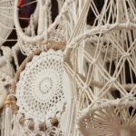 Detailed close-up of intricate boho macrame art with varied patterns and hanging designs.