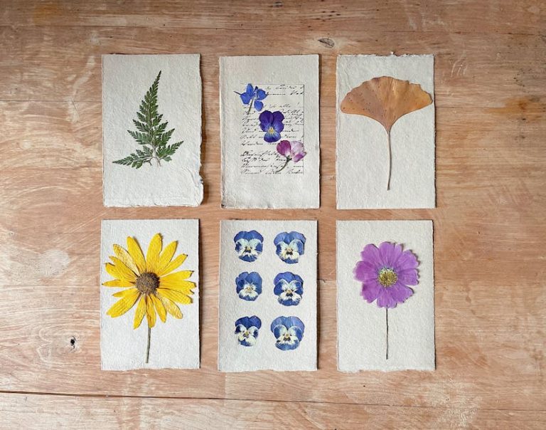 Discover detailed herbarium cards with pressed flowers on a rustic wooden table, showcasing botanical art.